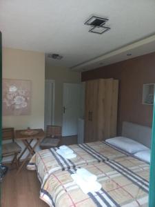 a bedroom with a large bed in a room at Velez IVANOVI DVORI in Jošanička Banja