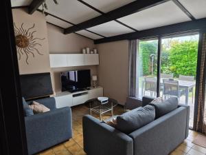 a living room with two couches and a television at Sunparks in Nieuwpoort
