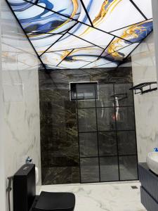 a bathroom with a shower with a stained glass ceiling at Novxanı Villa in Baku +7 photos