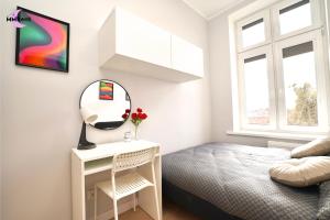 a bedroom with a bed and a mirror at MMRent Colorful Room in Gdańsk