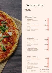 a menu for a pizza restaurant next to a pizza at Ferien Wohnung mit Seeblick in Romanshorn
