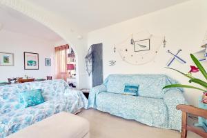 a living room with a couch and a chair at Panorama e Relax Lago Maggiore - piscina, tennis in Germignaga