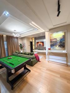 a living room with a pool table in it at Abuja Lux Apartment Wuye in Abuja