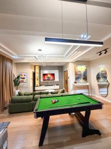 a living room with a pool table in it at Abuja Lux Apartment Wuye in Abuja