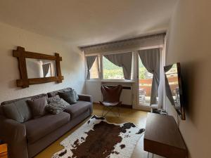 a living room with a couch and a window at Casa Raggio di Sole in La Thuile