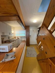 a kitchen with a wooden counter top in a room at Casa Raggio di Sole in La Thuile