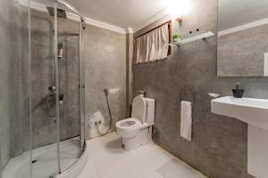 a bathroom with a shower and a toilet and a sink at Arches Fort in Galle +81 photos