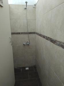 a bathroom with a shower with a tiled floor at Finca el gallego in Junín