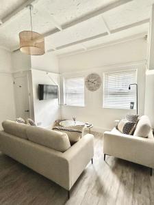 a living room with two couches and a table at Cosy Coastal Cottage in Tynemouth