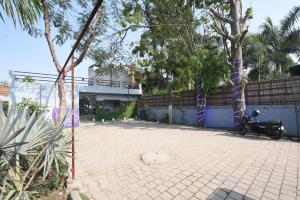 a courtyard with a motorcycle parked next to a fence at Hotel Stay 21 in Faridabad
