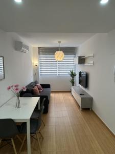 a living room with a couch and a table at APARTAMENTO FELIP 1 in Burriana