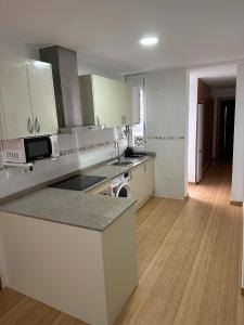 a kitchen with white cabinets and a counter top at APARTAMENTO FELIP 1 in Burriana