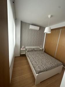 a small bedroom with a bed in a room at APARTAMENTO FELIP 1 in Burriana