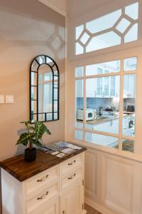 a kitchen with a large window and a counter at Kispolgár Vendégház in Sárospatak +76 photos