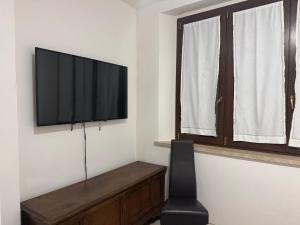 a living room with a flat screen tv on a wall at Villa Flavia in Arezzo