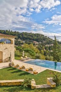 a villa with a swimming pool and a yard at Ideal BnB, Luxury Apartments in Saint Paul de Vence