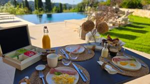 a blue table with food and a bottle of beer at Ideal BnB, Luxury Apartments in Saint Paul de Vence