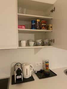 a kitchen counter with a coffee maker on a shelf at Monaco Studio "907" in Monte Carlo