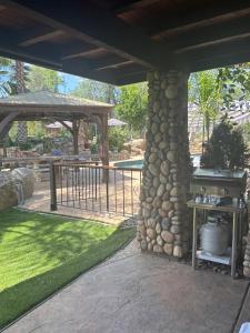 a patio with a stone pillar and a grill at Grand Studio with Resort Amenities in Alpine