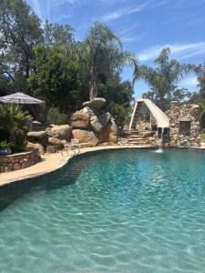 a swimming pool with a water slide in a yard at Grand Studio with Resort Amenities in Alpine
