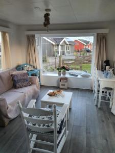 a living room with a couch and a table at Woonwagen Carpe Diem in Oudwoude