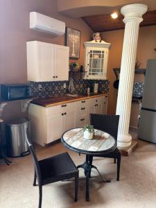 a kitchen with a table and two chairs and a refrigerator at Grand Studio with Resort Amenities in Alpine