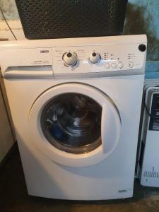 a white washer and dryer sitting in a room at Woonwagen Carpe Diem in Oudwoude