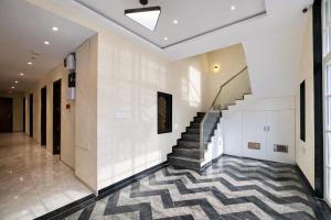 a hallway with a staircase in a building at Travinities Premier, Ujjain in Ujjain