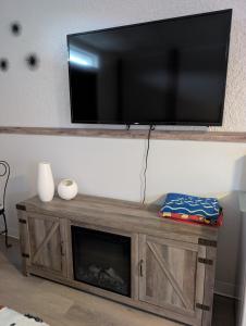 a flat screen tv on a wall above a fireplace at Endless Summer in Summerland