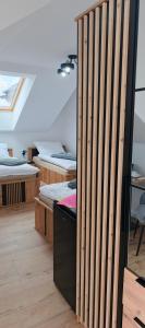a room with several beds and a wooden wall at Wakacyjna Pokusa in Kroczyce