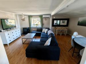 a living room with a couch and a tv at Familjenest in Bollnäs