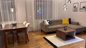 a living room with a couch and a table at SiM Lux in Čačak