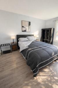 a bedroom with a large bed and two lamps at Black door bungalow in Windsor