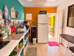 a kitchen with a white refrigerator in a room at Tico-living in Alajuela