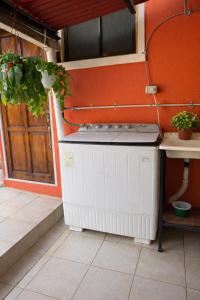 a kitchen with a stove top oven next to a door at Tico-living in Alajuela +9 photos