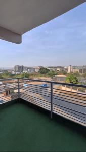 a balcony with a view of a car on a highway at Abuja Lux Apartment Wuye in Abuja