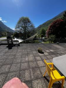 a yellow chair sitting on top of a patio at Giada in Iragna