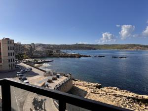 a view of a body of water from a balcony at Brand new Oceanview Penthouse by MaBeLi in St. Paul's Bay