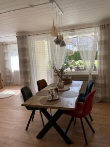 a dining room with a table and chairs and a window at Ferienwohnung Stadt-Wald-Park in Bad Harzburg +8 photos