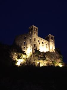 a castle sitting on top of a hill at night at La Yucca in Dolceacqua