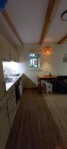 a kitchen with a sink and a table in a room at Szarotka in Brenno +16 photos