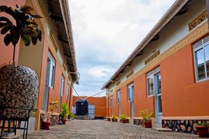 a courtyard of a building with a potted plant at Peak Motel in Kasese