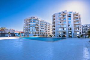 an empty swimming pool in front of two tall buildings at Scandic resort chalet in Hurghada