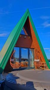 a house with a green and orange roof at Hot Tub Paradise - Squirrel's House in Žabljak
