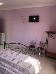 a bedroom with a bed and a tv on the wall at Hotel El Maghreb in Constantine +14 photos