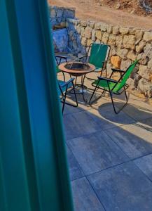 a group of chairs and a table and a fire pit at Hot Tub Paradise - Squirrel's House in Žabljak +17 photos