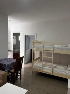 a room with two bunk beds and a chair at H Veza in Spille