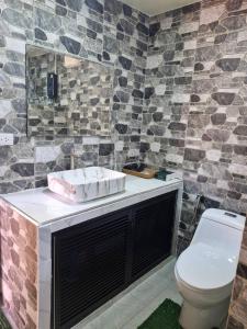 a bathroom with a sink and a toilet at Echo Falls Khanom in Ban Nua Tha