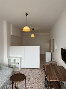 a room with a table and two chairs and a bed at Evdilos Icaria 'Sto Plakostroto' by BRP-Properties in Evdilos