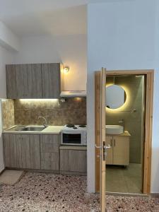 a kitchen with a sink and a stove at Evdilos Icaria 'Sto Plakostroto' by BRP-Properties in Evdilos +3 photos